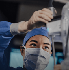 A surgeon operating the Da Vinci system